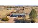 Charming home featuring mature landscaping, a cozy front porch and gravel driveway, with multiple outbuildings at 200 Bothun Rd, Berthoud, CO 80513
