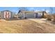 Attached two-car garage and shed in the backyard, featuring a gravel driveway and brick trim at 200 Bothun Rd, Berthoud, CO 80513