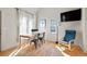 Dining area with lots of sunlight and view to kitchen with white cabinetry at 103 Sunset St # A, Longmont, CO 80501