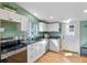 Well-lit kitchen with white cabinets, stainless steel appliances, and a window over the sink at 103 Sunset St # A, Longmont, CO 80501