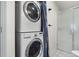 Practical laundry area with stacked washer and dryer, and a shower in a combined utility space at 103 Sunset St # A, Longmont, CO 80501