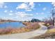 Scenic view of a community pond with a walking path and lush natural surroundings at 103 Sunset St # A, Longmont, CO 80501