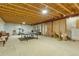 Unfinished basement area with exposed beams, ping pong table and space for recreation at 18090 E 47Th Dr, Denver, CO 80249