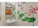Bright half-bathroom featuring pedestal sink and attractive lotus flower wall decor at 18090 E 47Th Dr, Denver, CO 80249