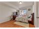 Bedroom featuring wood floors, natural light, and tv at 18090 E 47Th Dr, Denver, CO 80249
