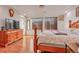Bedroom with wood floors, natural light, and dresser at 18090 E 47Th Dr, Denver, CO 80249