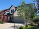 Two-story home featuring a two-car garage and well-kept landscaping at 18090 E 47Th Dr, Denver, CO 80249
