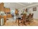 Open kitchen and dining area featuring wood floors, granite counters, bar seating, and stainless steel appliances at 18090 E 47Th Dr, Denver, CO 80249