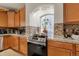 Close-up of kitchen featuring tile backsplash, granite countertops, stainless steel appliances, and bright window at 18090 E 47Th Dr, Denver, CO 80249