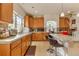 Bright kitchen with large island, granite countertops, stainless appliances, and wood cabinets at 18090 E 47Th Dr, Denver, CO 80249