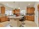Spacious kitchen with large center island, granite countertops, bar seating, and stainless steel appliances at 18090 E 47Th Dr, Denver, CO 80249