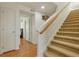 Carpeted stairs leading to the upper level with light wood trim and white walls at 18090 E 47Th Dr, Denver, CO 80249