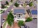 Aerial view of a home with solar panels, a patio, and landscaping at 1586 S Goldbug Cir, Aurora, CO 80018