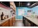 Basement wet bar features dark cabinets, granite countertop, and tiled floor at 1586 S Goldbug Cir, Aurora, CO 80018