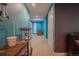 Finished basement hallway featuring bright blue walls and access to various rooms at 1586 S Goldbug Cir, Aurora, CO 80018