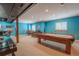 Spacious basement with a pool table, seating area, and blue walls at 1586 S Goldbug Cir, Aurora, CO 80018