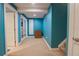 Finished basement with bright blue walls, carpeted floor, and natural light at 1586 S Goldbug Cir, Aurora, CO 80018