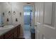 Hall bathroom with Avengers themed decorations, tiled shower/tub and single sink vanity at 1586 S Goldbug Cir, Aurora, CO 80018