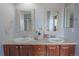 Bathroom with double sink vanity, white cabinets, and decorative mirrors for added style at 1586 S Goldbug Cir, Aurora, CO 80018