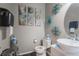 Stylish powder room features vessel sink, tile accent wall and decorative wall art at 1586 S Goldbug Cir, Aurora, CO 80018