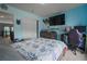 Bedroom with blue walls, a large bed and a gaming setup with lots of natural light at 1586 S Goldbug Cir, Aurora, CO 80018