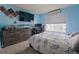 Bedroom with blue walls, large bed, TV and window for natural light and modern furniture at 1586 S Goldbug Cir, Aurora, CO 80018
