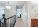 Bright hallway with modern lighting, neutral walls, and access to bedrooms and bathrooms at 1586 S Goldbug Cir, Aurora, CO 80018