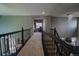Upstairs hallway with a view of the great room's chandelier and railing overlooking the space at 1586 S Goldbug Cir, Aurora, CO 80018