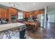 Stylish kitchen features wood cabinetry, black countertops and modern stainless steel appliances and an island with stools at 1586 S Goldbug Cir, Aurora, CO 80018