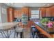Stylish kitchen features wood cabinetry, black countertops and modern stainless steel appliances at 1586 S Goldbug Cir, Aurora, CO 80018