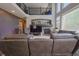 Spacious living room with fireplace, soaring windows, and comfortable leather seating at 1586 S Goldbug Cir, Aurora, CO 80018