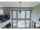 Bright and airy living room with soaring ceilings, large windows, and a stylish chandelier at 1586 S Goldbug Cir, Aurora, CO 80018