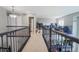Open loft area features plush carpet, dark railing, and views of the main floor at 1586 S Goldbug Cir, Aurora, CO 80018