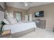 Main bedroom features a large bed, ceiling fan, TV and modern dresser at 1586 S Goldbug Cir, Aurora, CO 80018