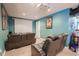 Bright home theater room features large screen and comfortable seating for an immersive experience at 1586 S Goldbug Cir, Aurora, CO 80018