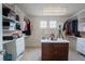 Spacious walk-in closet with custom shelving, drawers, and ample storage space with vanity table at 1586 S Goldbug Cir, Aurora, CO 80018
