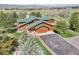 Aerial view of the stunning mountain cabin with a long driveway and an attached three-car garage at 3557 Palmer Ridge Dr, Parker, CO 80134
