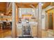 Charming bar area featuring custom cabinets, a wine refrigerator, and decorative lighting at 3557 Palmer Ridge Dr, Parker, CO 80134