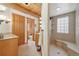 Bright log cabin bathroom with tiled shower and convenient built-in bench seating at 3557 Palmer Ridge Dr, Parker, CO 80134