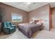 Spacious bedroom with chair, plush carpeting, natural light, and closet at 3557 Palmer Ridge Dr, Parker, CO 80134