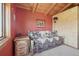 Comfortable bedroom with cozy daybed, wooden furniture, and natural light at 3557 Palmer Ridge Dr, Parker, CO 80134