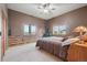 Comfortable bedroom with unique wall details, windows with scenic views, and plush carpeting at 3557 Palmer Ridge Dr, Parker, CO 80134