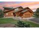 Stunning log home featuring a green roof, stone accents, and a meticulously landscaped front yard at 3557 Palmer Ridge Dr, Parker, CO 80134
