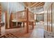 Unique foyer with custom woodwork, tile floors, and an open staircase with log accents at 3557 Palmer Ridge Dr, Parker, CO 80134