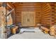 Inviting log home entrance featuring carved wooden doors, a bear carving, and comfortable seating at 3557 Palmer Ridge Dr, Parker, CO 80134