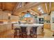 Gourmet kitchen featuring an island with bar seating, stainless steel appliances, and light wooden cabinetry at 3557 Palmer Ridge Dr, Parker, CO 80134