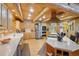 Spacious kitchen with stainless appliances, a center island, and wooden cabinets and ceilings at 3557 Palmer Ridge Dr, Parker, CO 80134