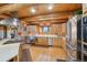Modern kitchen with stainless steel appliances, wood cabinets, and views of the wooded landscape at 3557 Palmer Ridge Dr, Parker, CO 80134
