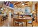 Inviting great room features a stone fireplace, wood beams, and beautiful hardwood floors throughout the house at 3557 Palmer Ridge Dr, Parker, CO 80134