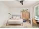 Cozy bedroom featuring a ceiling fan, a large window, and stylish furnishings at 40 S Dexter St, Denver, CO 80246
